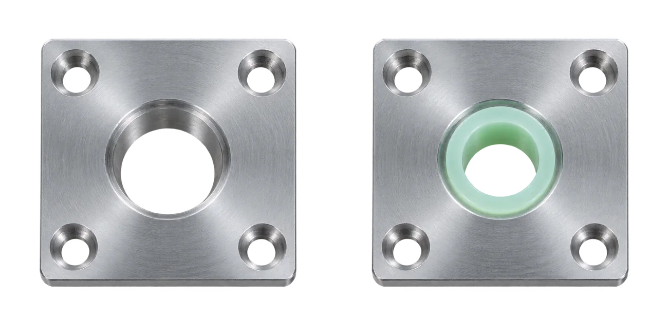 Two illustrative aluminium plates: the original has an empty central bore; the revised version includes a jade-colored bushing.